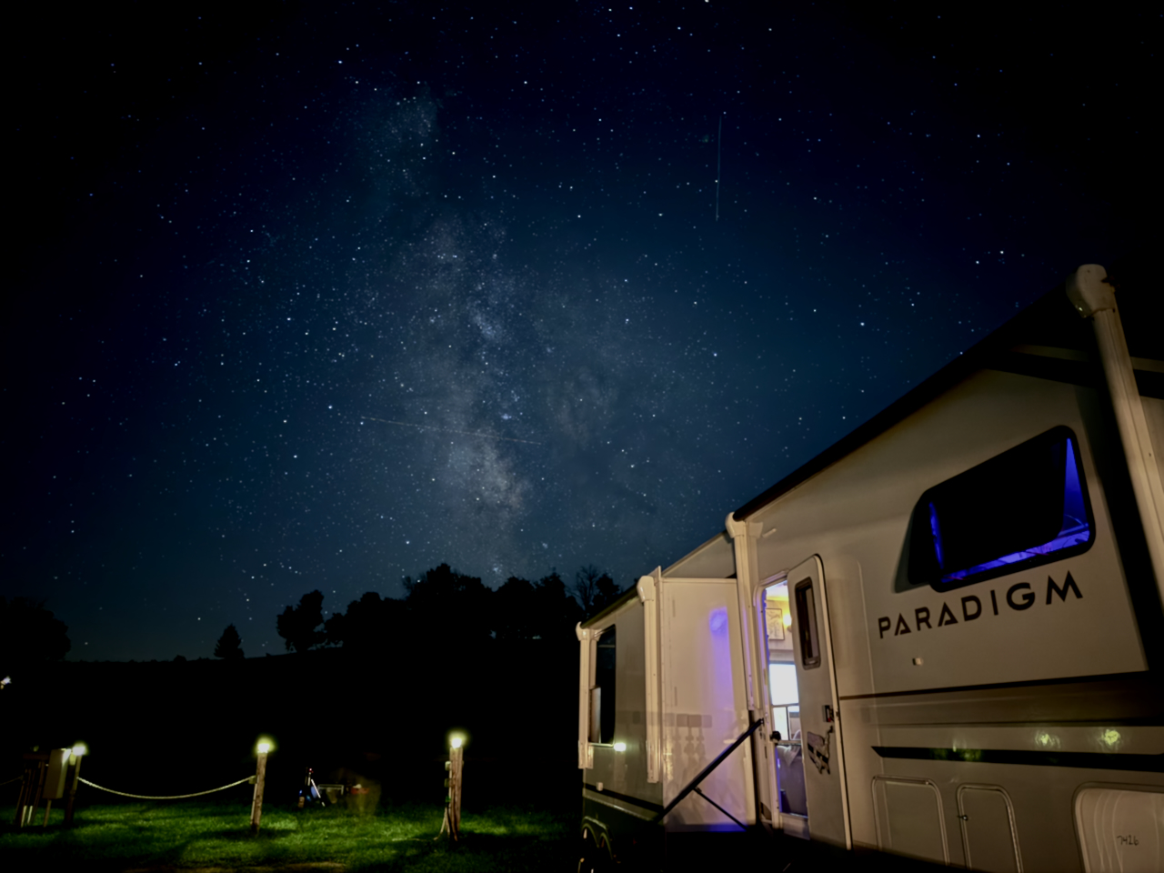 A meteor streaking past the Milky Way above camp