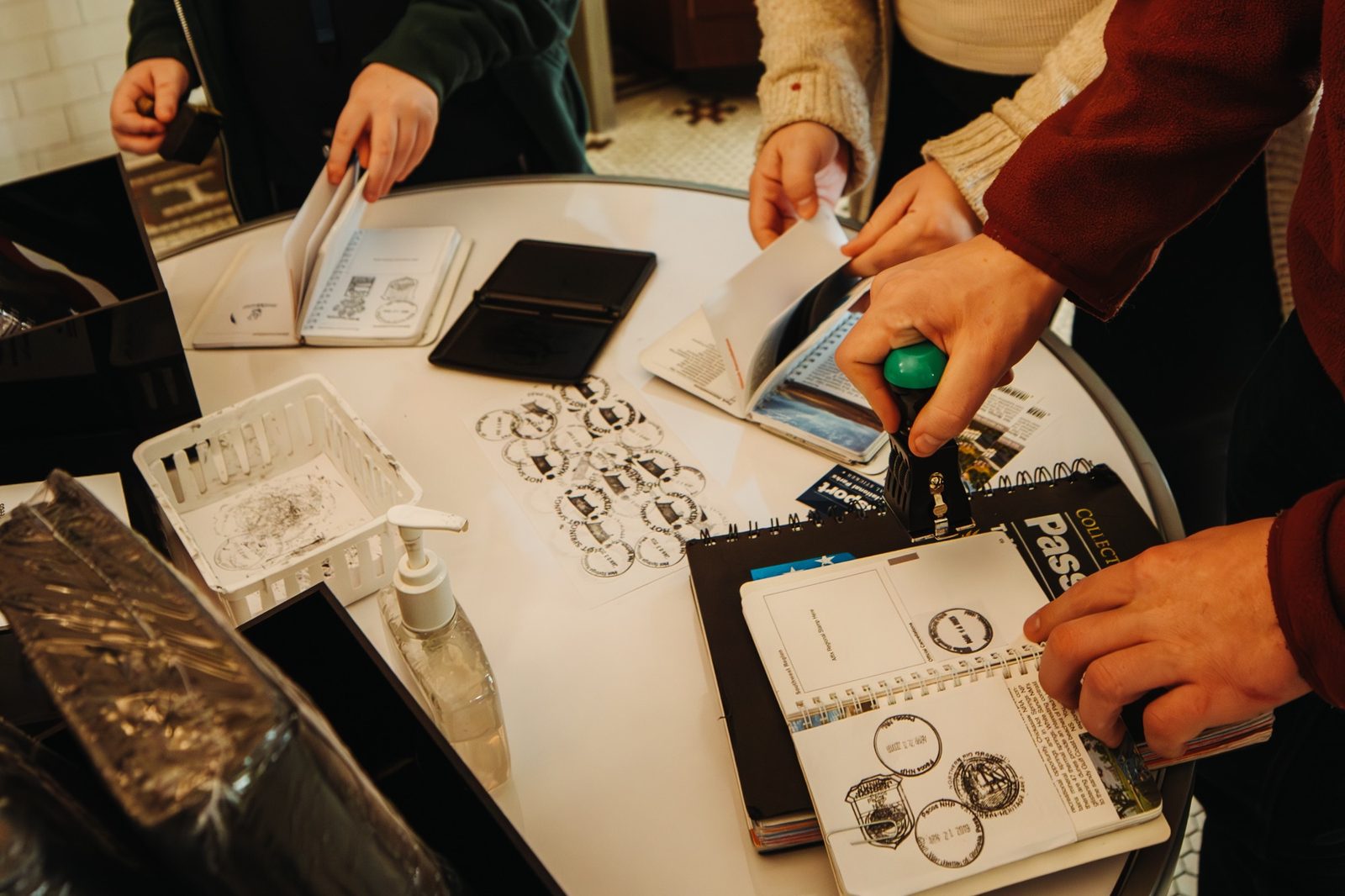 People stamping National Park Passport books at the stamp table