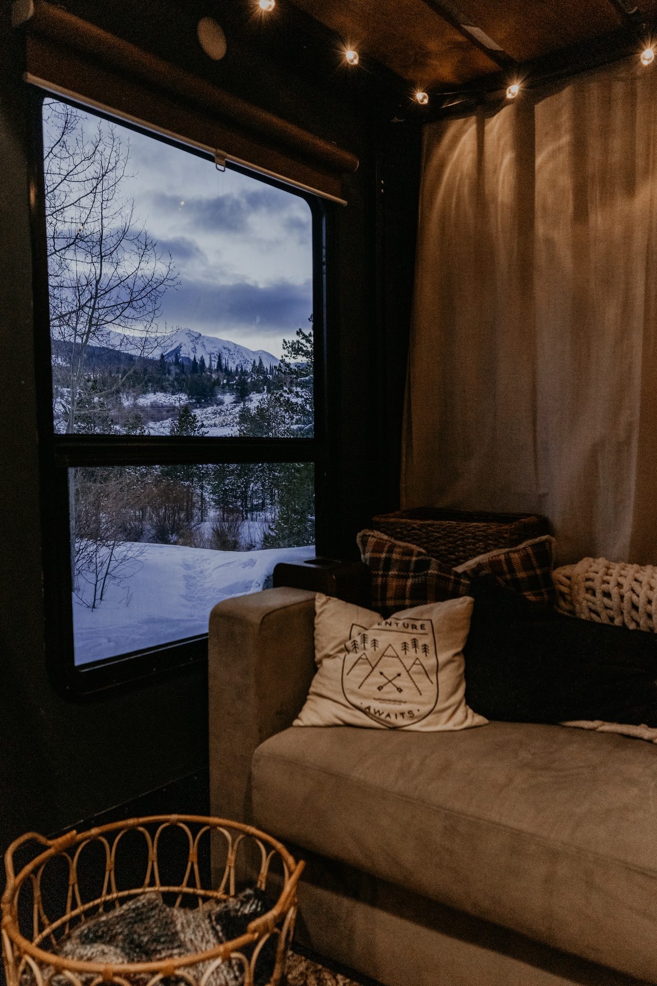 inside an rv looking out a window onto the mountains snow topped